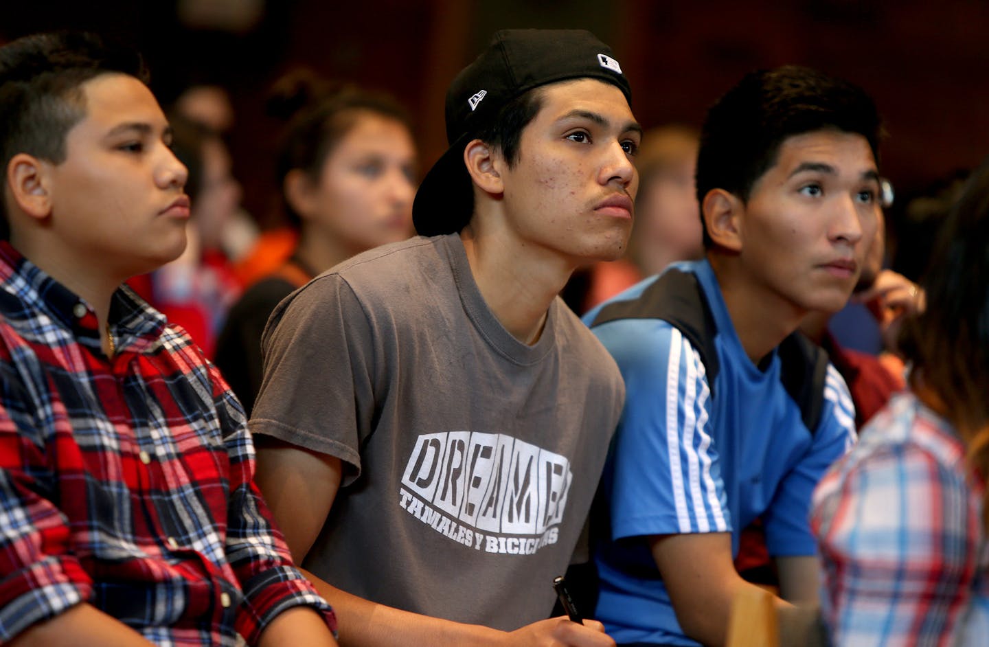 Jose Gomez, left, wearing a "Dreamer" t-shirt Nestor Gomez, center, and Francisco Chavez took notes during a Dream Act workshop at Augsburg College, Monday, August 19, 2013 in Minneapolis, MN. Now that the Minnesota Dream Act is state law, activists want to make sure students take advantage of the state help to pay their college costs. There was a public meeting Monday at Augsburg College to explain it to students who may qualify - undocumented immigrants who have lived here at least three years