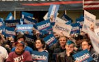 Supporters of Bernies Sanders waved signs as they waited for him to arrive at a rally at Roy Wilkins Auditorium in St. Paul, on Monday, March 2, 2020.