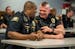 St. Paul police officers Brad Chin, left, and Lou Ferraro sat together during roll call on May 31. When Chin was a teenager working as a shift supervi