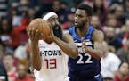 Houston Rockets guard James Harden (13) looks to pass the ball under pressure from Minnesota Timberwolves forward Andrew Wiggins (22) during the first