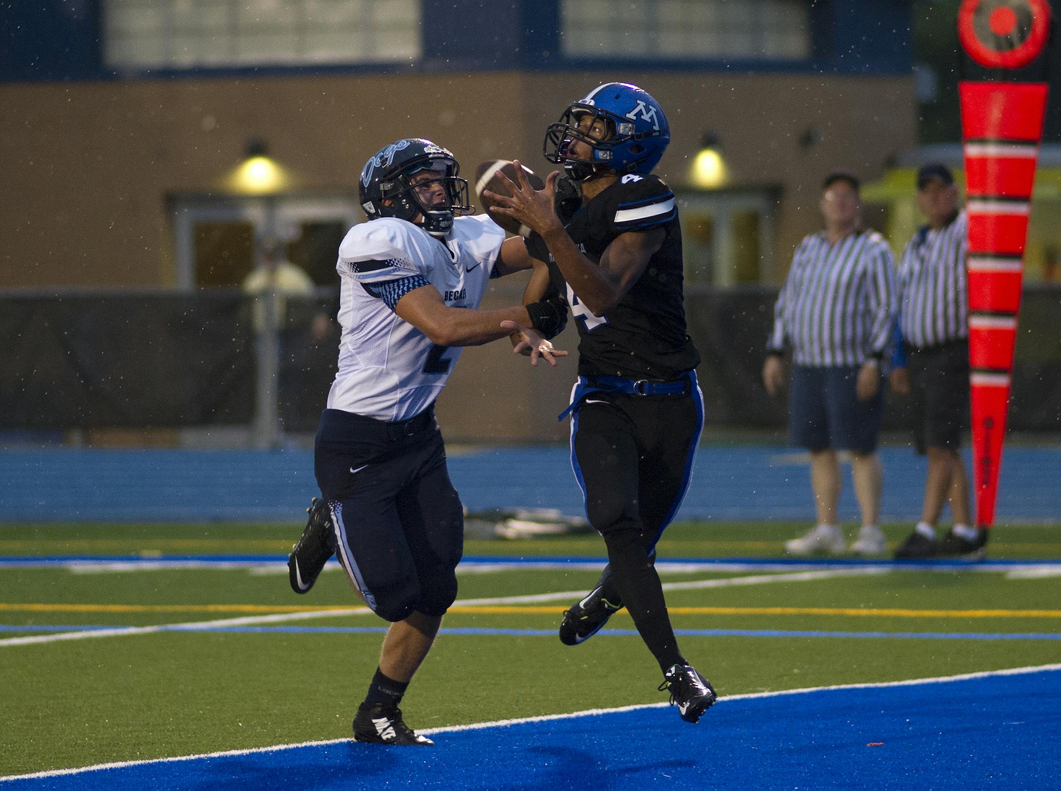 Minnetonka's Matthew Watt recieves a pass ahead of the hands of Becker's Alex Meidt during Friday's game at Minnetonka. ] (Matthew Hintz, 083014, Minnetonka)