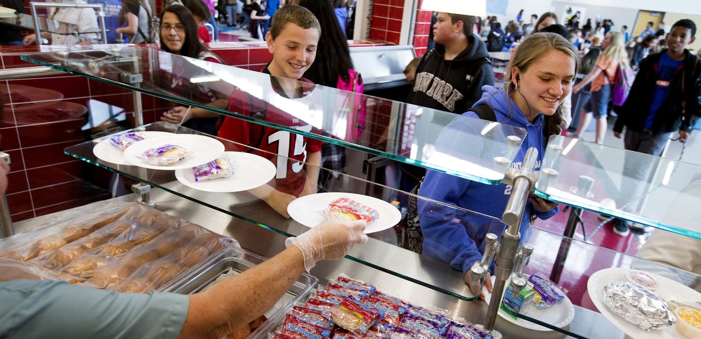 In a May 19, 2017 photo, Mount Jordan Middle School students get lunch in their school's cafeteria in Sandy, Utah. Canyons School District administrators are proposing that the school board adopt a policy that takes a kinder, gentler approach to school nutrition service to children whose accounts are in arrears. (Laura Seitz/The Deseret News via AP)/The Deseret News via AP) ORG XMIT: MIN2017070713265938