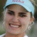 Lexi Thompson holds up the trophy after winning the Kraft Nabisco Championship golf tournament Sunday, April 6, 2014, in Rancho Mirage, Calif. (AP Pho