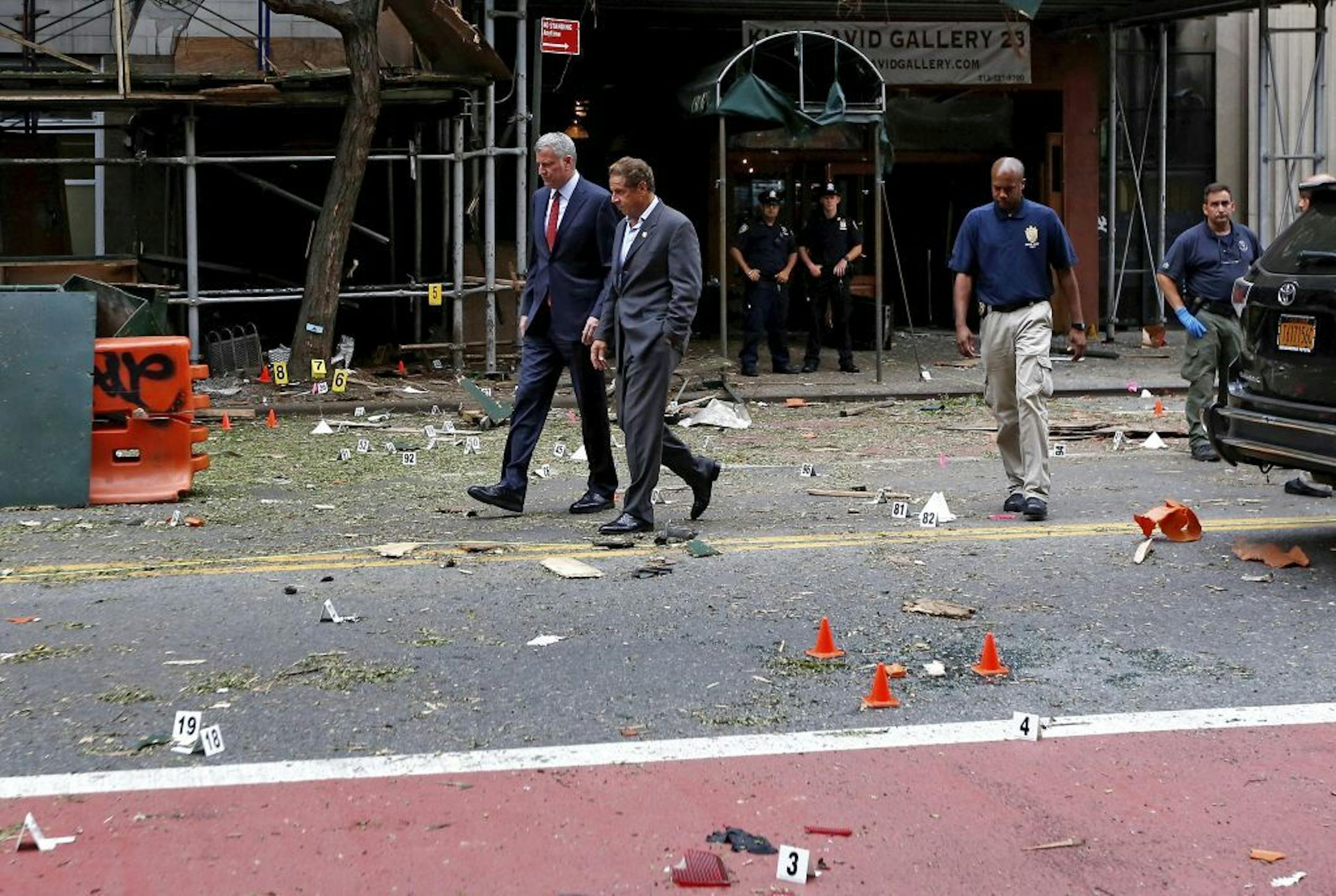 Gov. Andrew Cuomo, left, and Mayor Bill de Blasio talk while touring the site of last night's explosion in the Chelsea neighborhood of New York, Sept. 18, 2016. Cuomo said that the bomb blast did not appear to be linked to international terrorism.