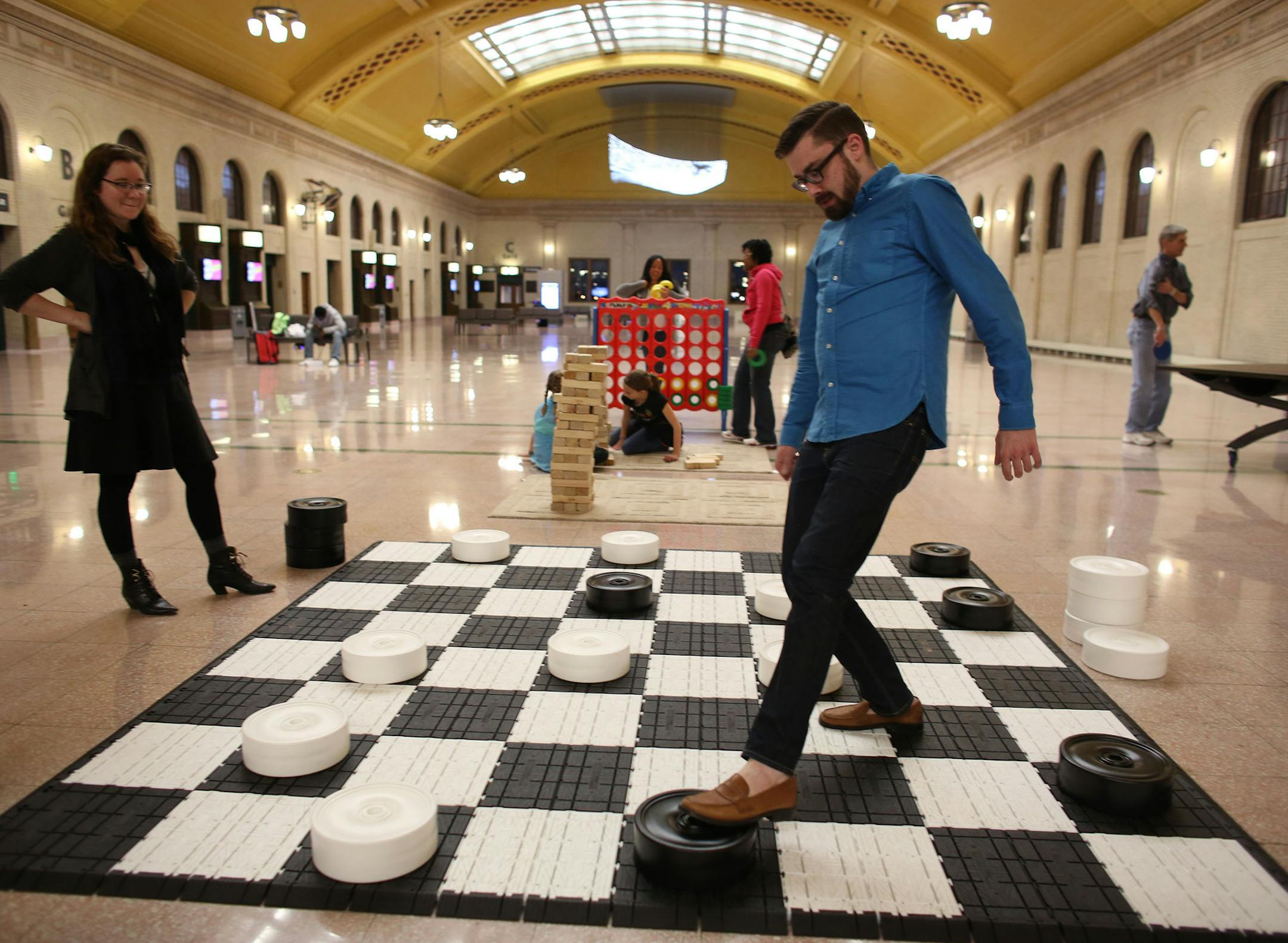 Kelly Krantz, of Minneapolis and Tim Sullivan, of St. Paul, challenging each other as they played checkers on their date night. ] (KYNDELL HARKNESS/STAR TRIBUNE) kyndell.harkness@startribune.com The Union Depot on game night in St. Paul Min., Wednesday, October 15, 2014.