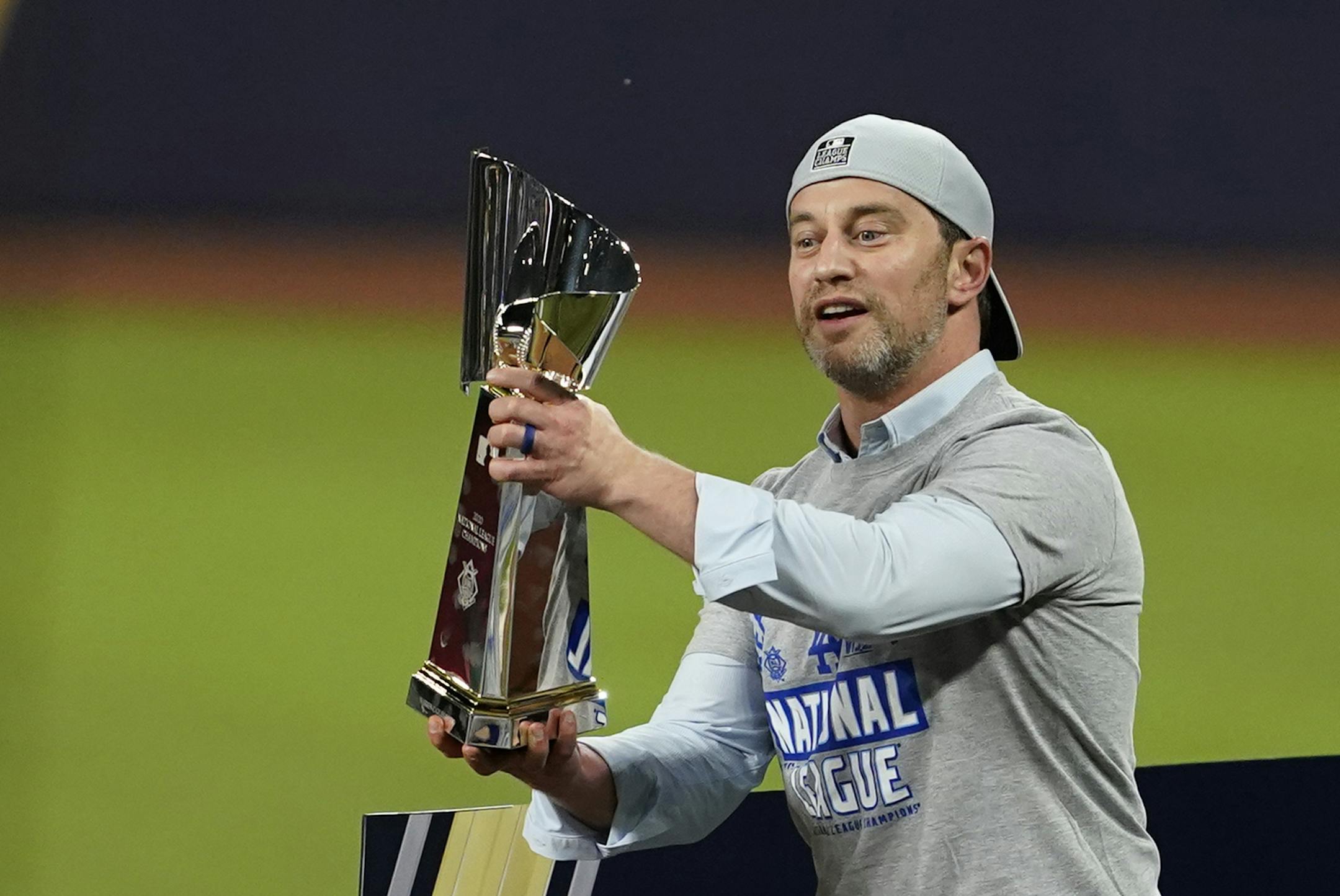 Los Angeles Dodgers President of Baseball Operations Andrew Friedman celebrate with the trophy after winning Game 7 of a baseball National League Championship Series against the Atlanta Braves Sunday, Oct. 18, 2020, in Arlington, Texas. (AP Photo/Tony Gutierrez)