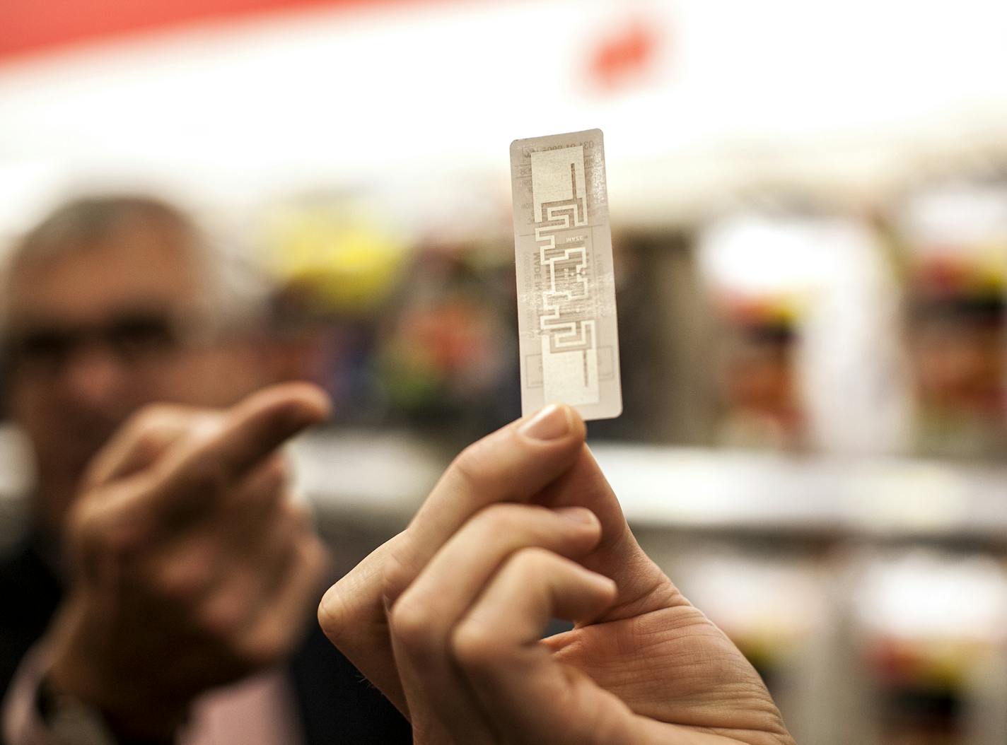 Mike McNamara, Chief Information Officer at Target, points to an RFID tag as he describes how RFID tags and scanners can greatly increase the speed and efficiency of tracking inventory at the Target store on Nicollet Mall in Minneapolis September 15, 2015. (Courtney Perry/Special to the Star Tribune)