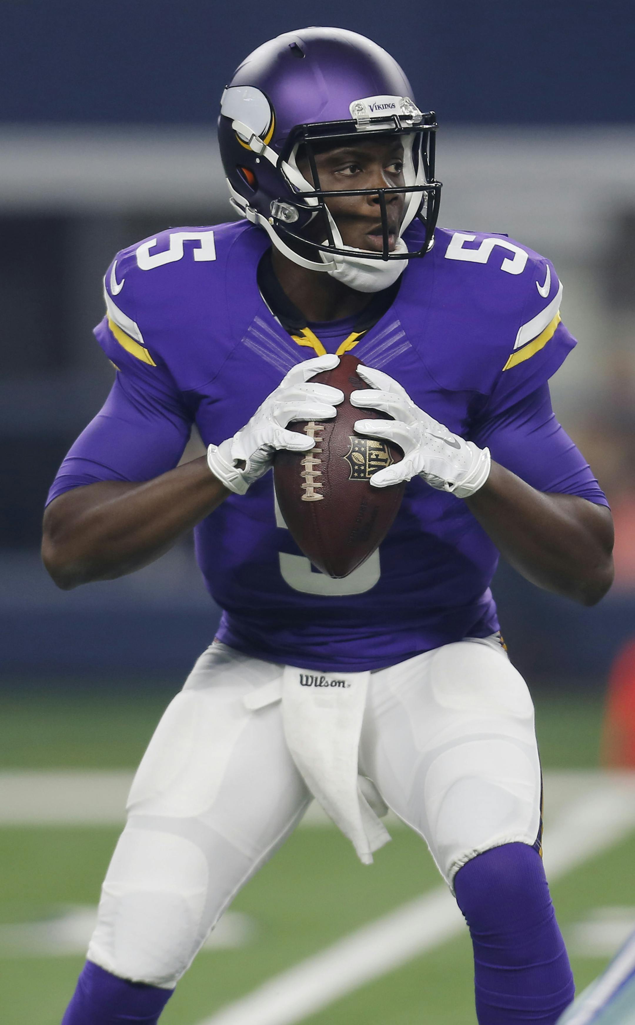 Minnesota Vikings quarterback Teddy Bridgewater (5) looks to pass as Dallas Cowboys defensive end Demarcus Lawrence (90) defends during the first half of a preseason NFL football game Saturday, Aug. 29, 2015, in Arlington, Texas. (AP Photo/Brandon Wade)