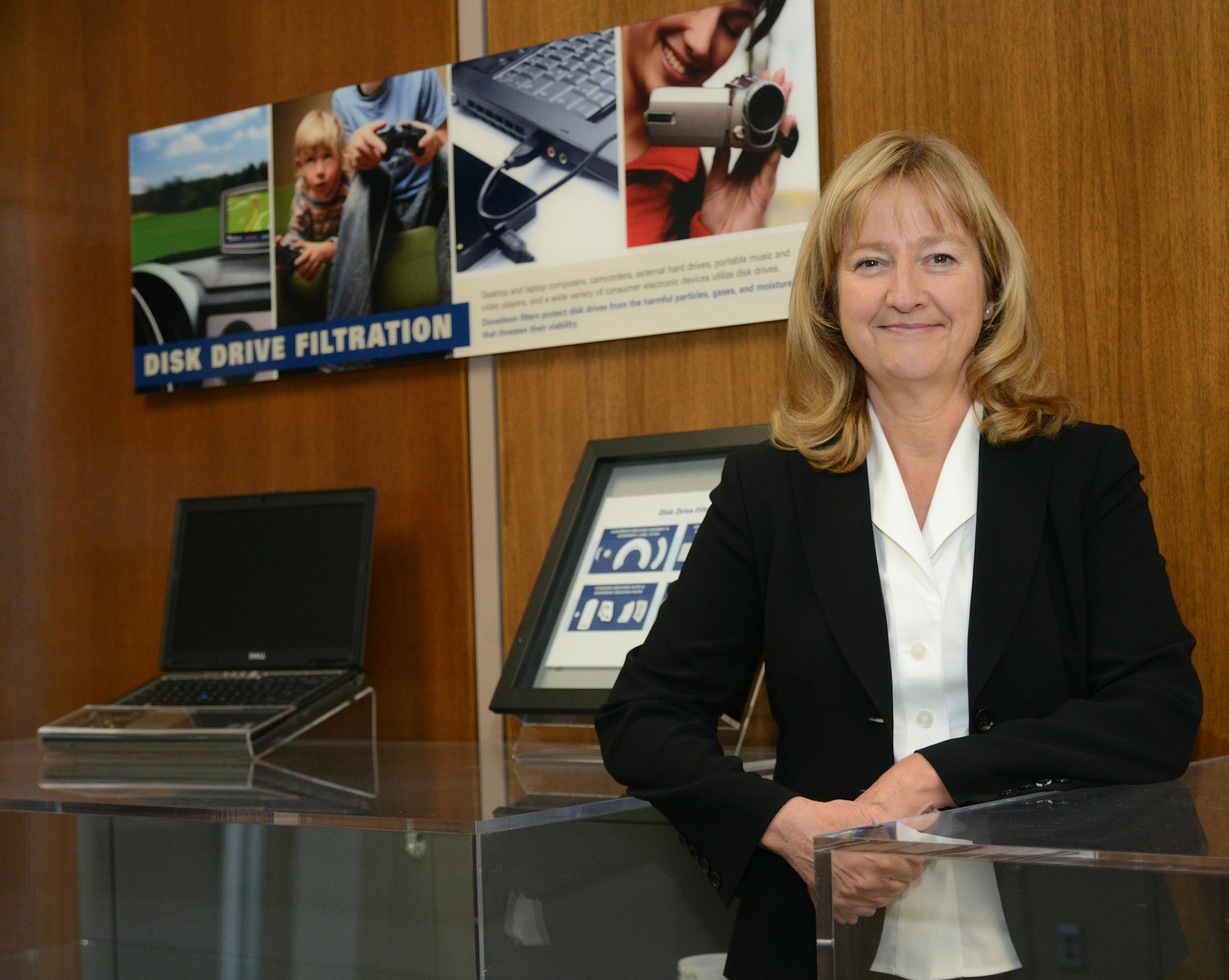 Vice President Peggy Herrmann of Donaldson Co. stands besides a display that show cases products that use Donaldson filters adapted from its declining business of filters for disk drives inside PCs. ] Richard.Sennott@startribune.com Richard Sennott/Star Tribune. , Bloomington Minn. Thursday 4/25/13) ** (cq)