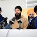From Left to right, Moninder Singh, Brabjot Singh, and Gurmeet Singh, listen to media questions during a news conference providing an update from the 