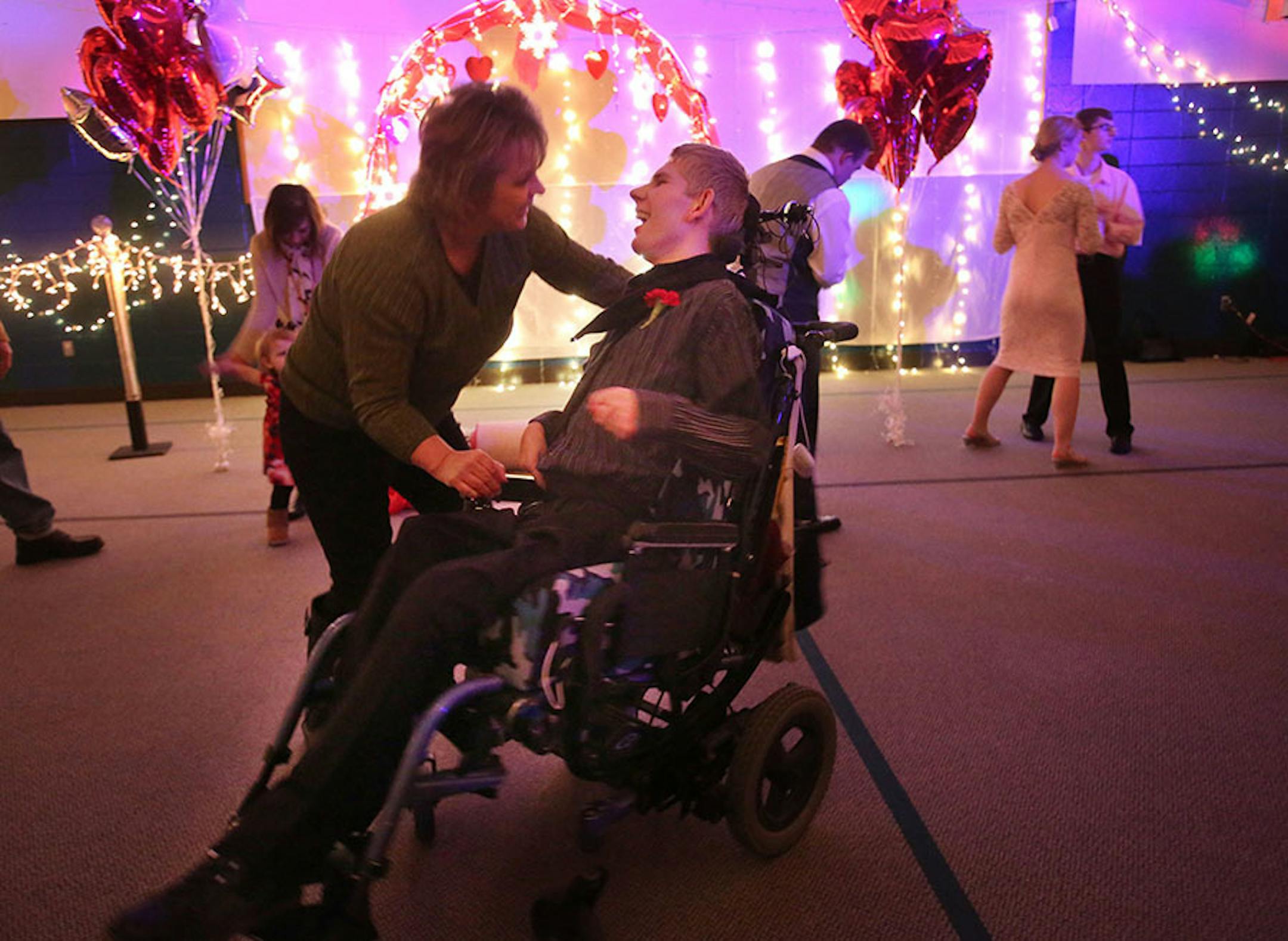 Matthew Larson of Savage gets a whirl from his mom Lisa Larson while on the dance floor at the Snowflake Ball Saturday, Feb. 20, 2016, at Ridgewood Church in Minnetonka. Lisa Larson described the dance at Matthew's "last fling," before he has hip surgery. Matthew has cerebral palsey.