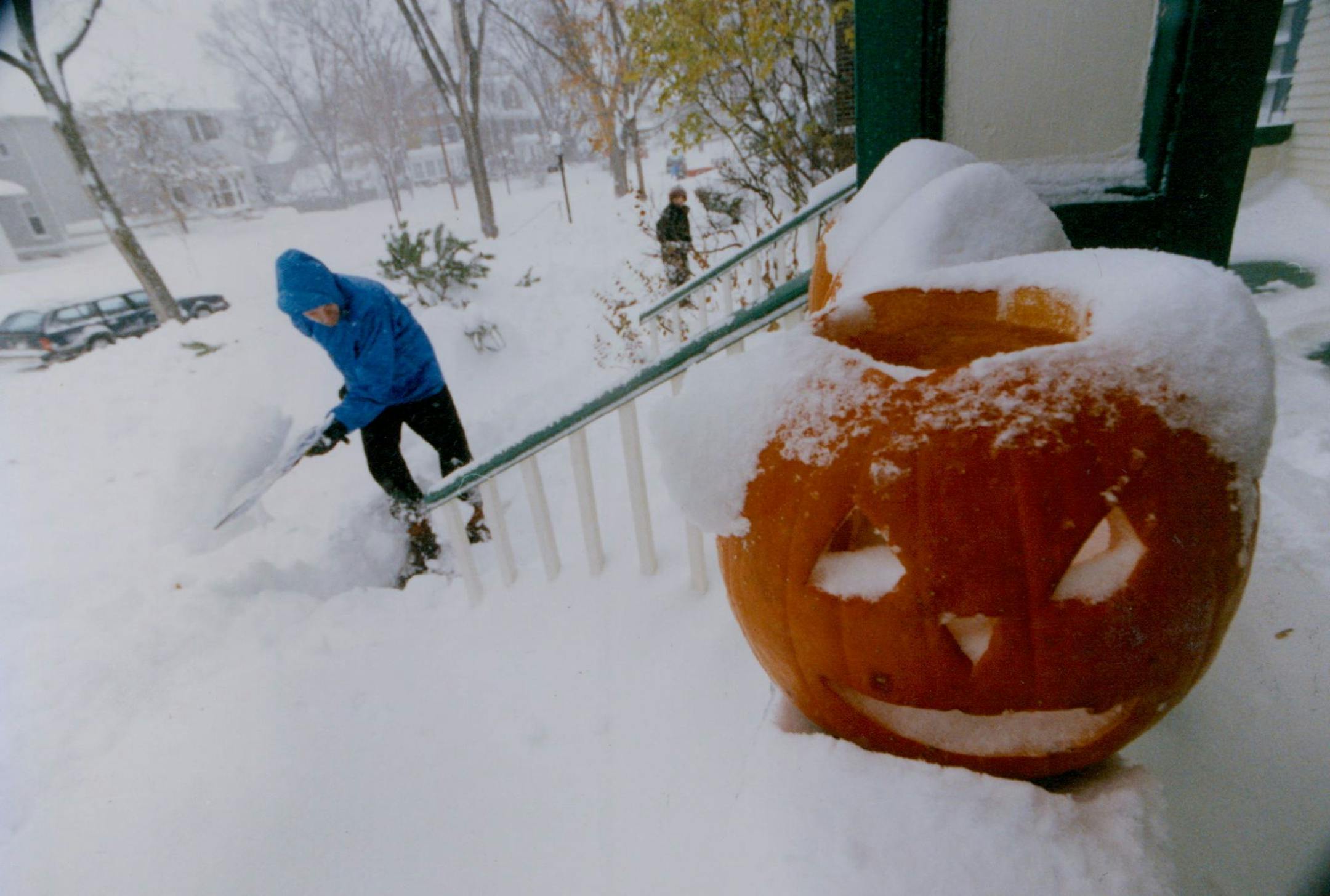 November 1, 1991 Halloween Blizzard feature photos. John Floberg shovels out his walk on James Ave. S. Mpls with a jack o latern a mute witness to the snow. November 3, 1991 Rick Sennott, Minneapolis Star Tribune