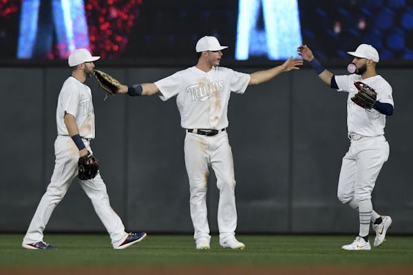 From left, Minnesota Twins right fielder Jake Cave (60), right fielder Max Kepler (26) and third baseman Marwin Gonzalez (9) celebrated their team's 8