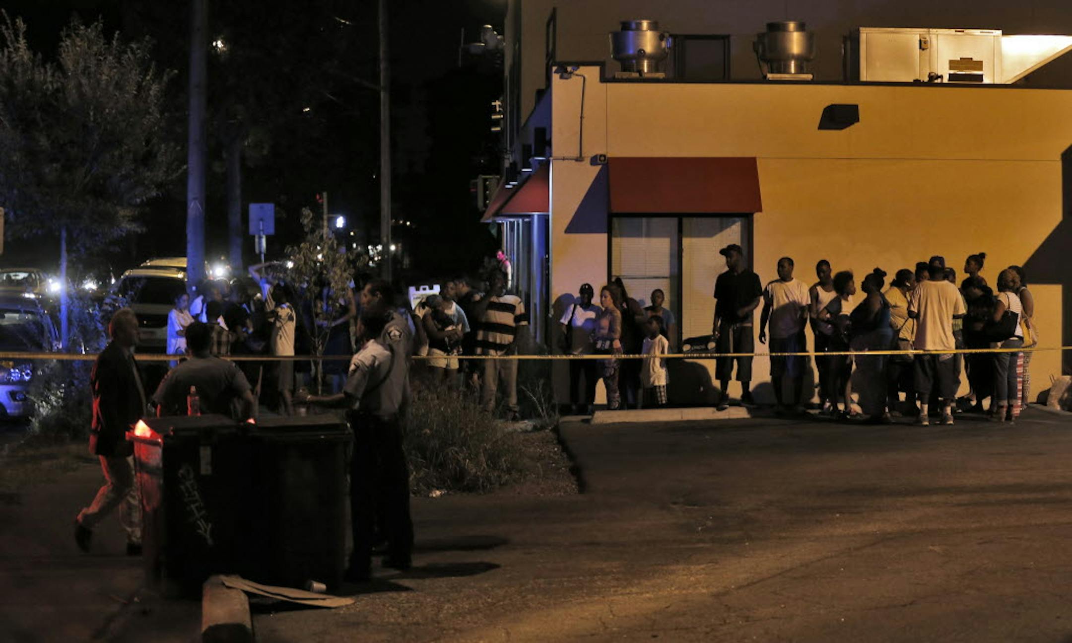 A crowd gathered near the scene of a shooting in an alley between Ceder Ave. and 18 Ave. S. and 26th and 27th St. in Minneapolis.
