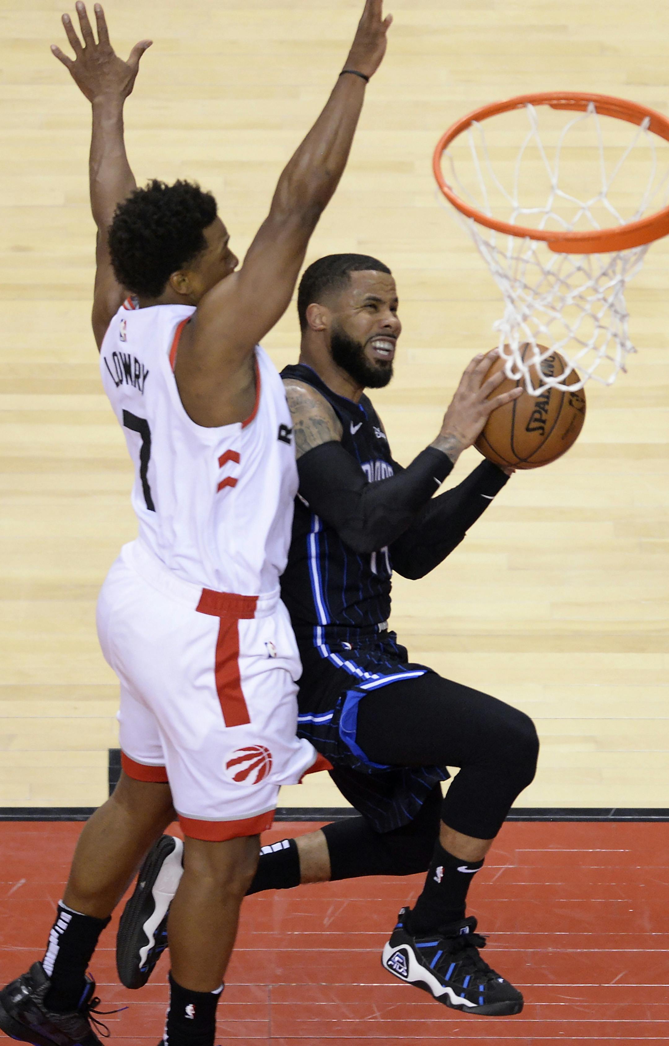 Toronto Raptors guard Kyle Lowry (7) fouls Orlando Magic guard D.J. Augustin (14) during the first half of Game 2 of an NBA basketball first-round playoff series Tuesday, April 16, 2019, in Toronto. (Nathan Denette/The Canadian Press via AP)