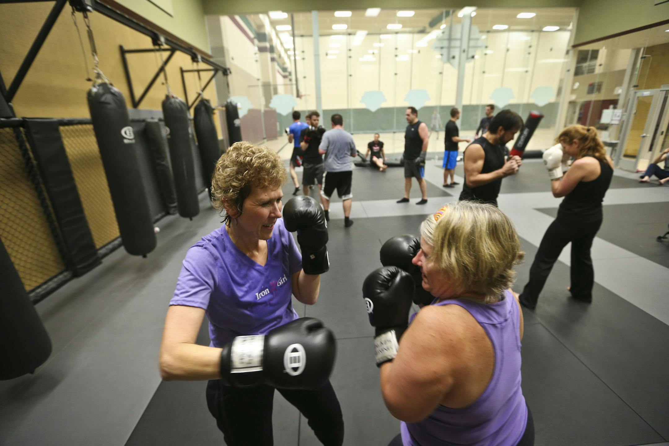 Julie Bruce, 49, of Shakopee, left, sparred with Diane Crist, 52, of Shakopee, during a Mixed Martial Arts workout class called "Fight Shape" at Lifetime Fitness on Monday, November 11, 2013 in Chanhassen, Minn. ] RENEE JONES SCHNEIDER • reneejones@startribune.com
