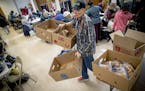 Open Hands Midway Director Kay Kuehn, removed boxes that were once filled with food but quickly were taken at their location, Monday, March 25, 2019 i