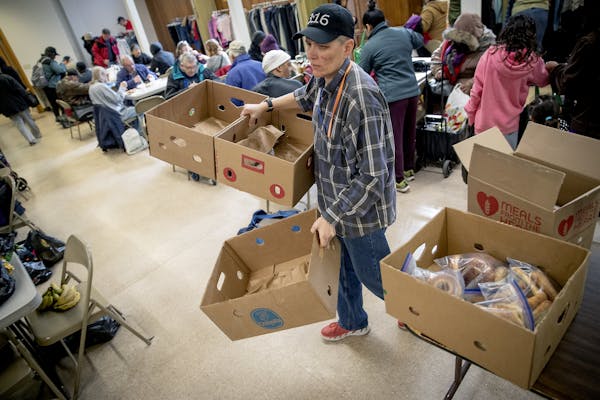 Open Hands Midway Director Kay Kuehn, removed boxes that were once filled with food but quickly were taken at their location, Monday, March 25, 2019 i