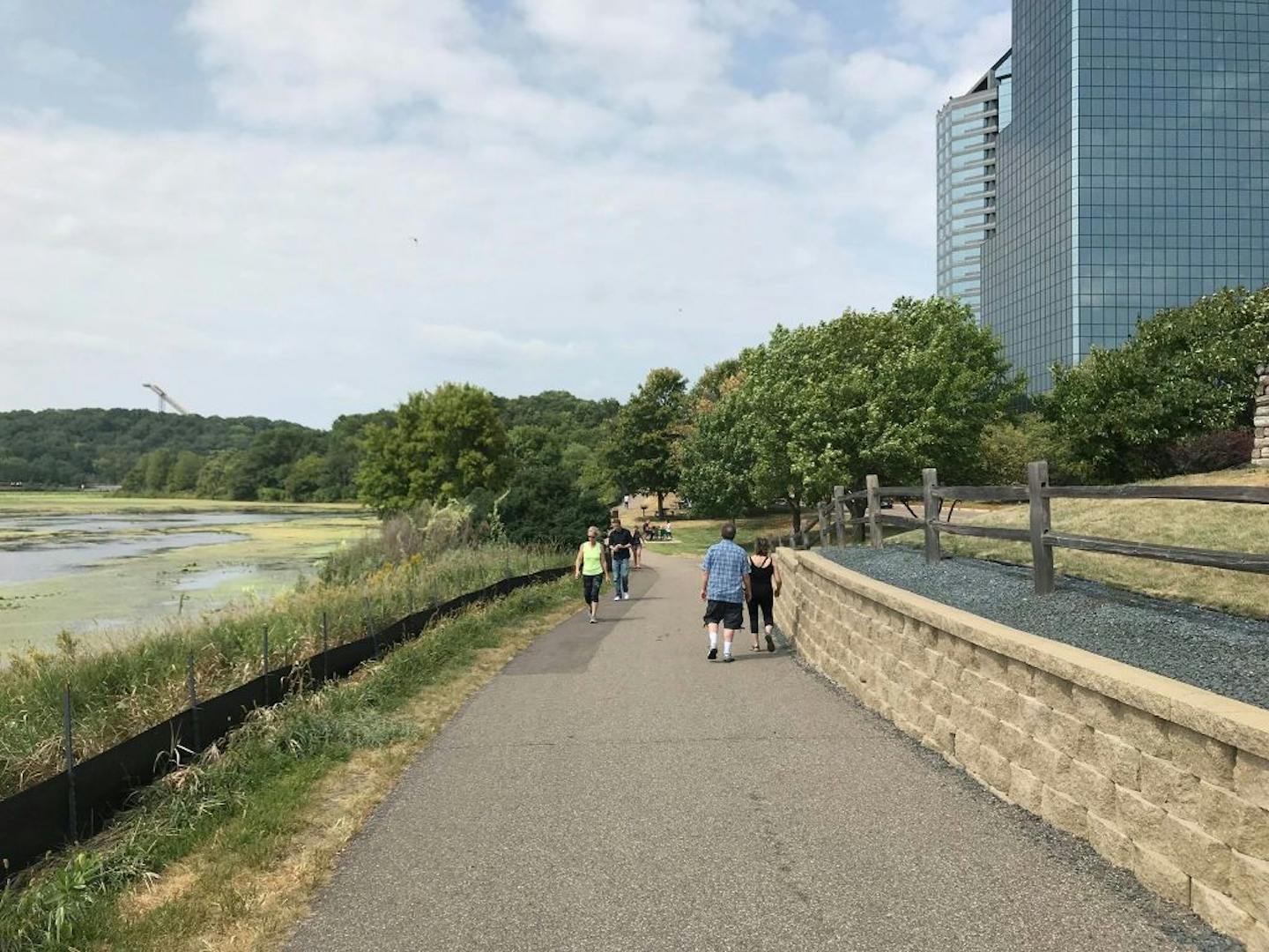 People walk along the pedestrian trails of Normandale Lake in Bloomington on Thursday, Aug. 23, 2018.