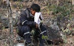 A volunteer wipes his face as he takes a break from fighting fires in the Chiquitania forest on the outskirts of Robore, Bolivia, Bolivia, Thursday, A