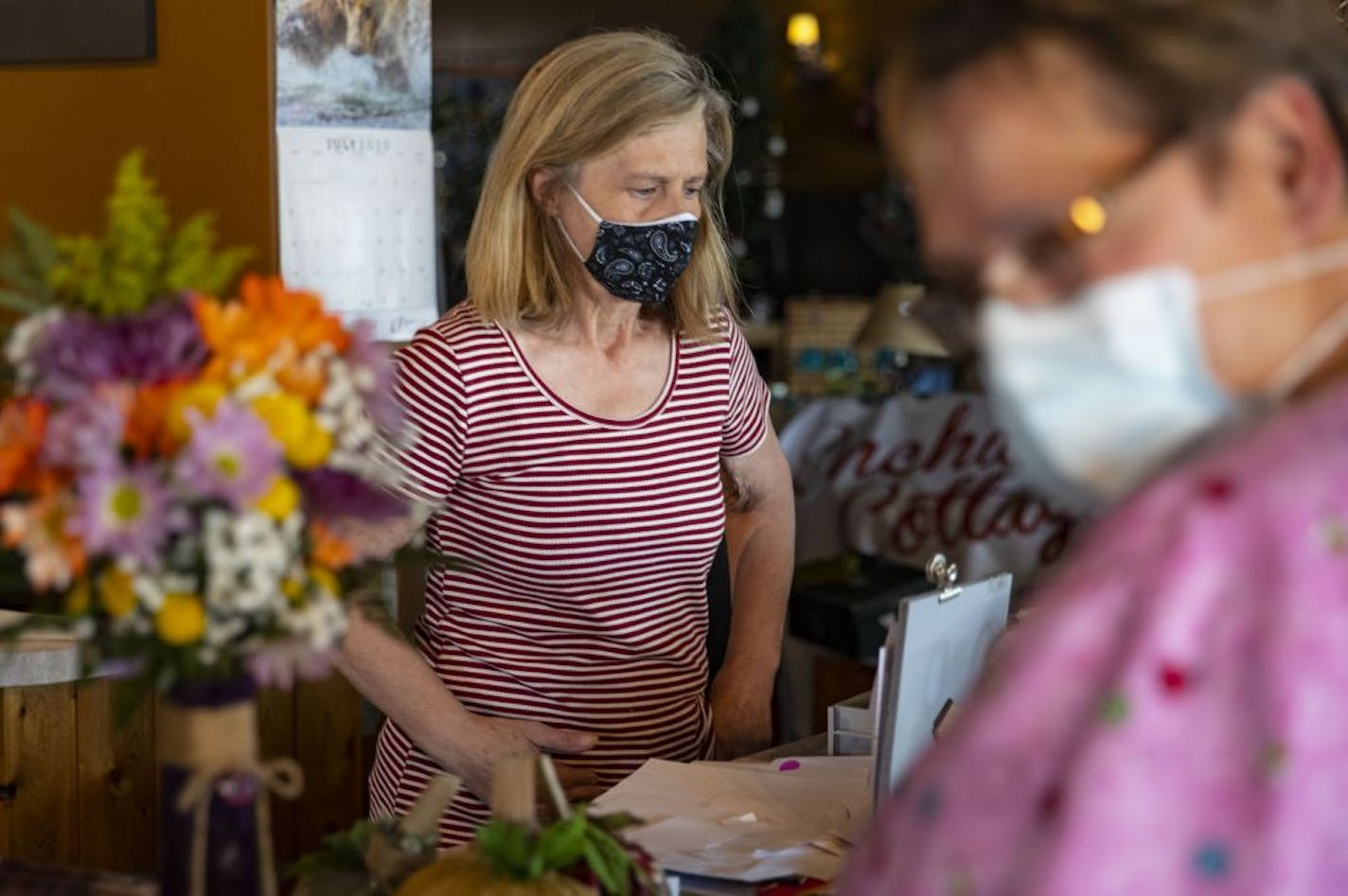 Lynn Furbish rang up Terri Poppitz in her store in Baudette, Minn. amidst the pandemic on Thursday. Furbish is only open three days a week and in a limited capacity.