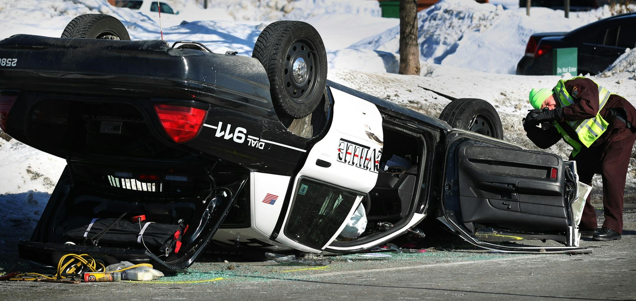 A state trooper took a picture of a Roseville squad car that flipped after a collision while responding to a report of a bank robbery.