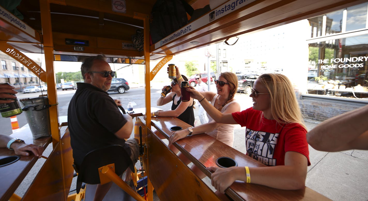 A group of co-workers who rented a Pedal Pub for a group activity toasted themselves as they headed out for their tour Thursday evening. The pilot for their tour was Jim Reed, left. The others are, from left, were Alexi Lund, Kayla Krebsbach, and Holly Anderson. ] JEFF WHEELER &#xef; jeff.wheeler@startribune.com Pedal Pubs were back on the streets Thursday night, June 25, 2015 in Minneapolis after one was hit on the Hennepin Ave. bridge the previous night.