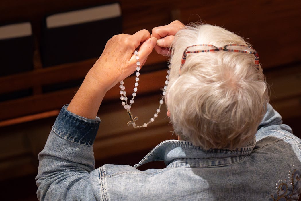 Sandra Toucholke prayed the rosary before the start of Friday Mass at St. Joseph Church.