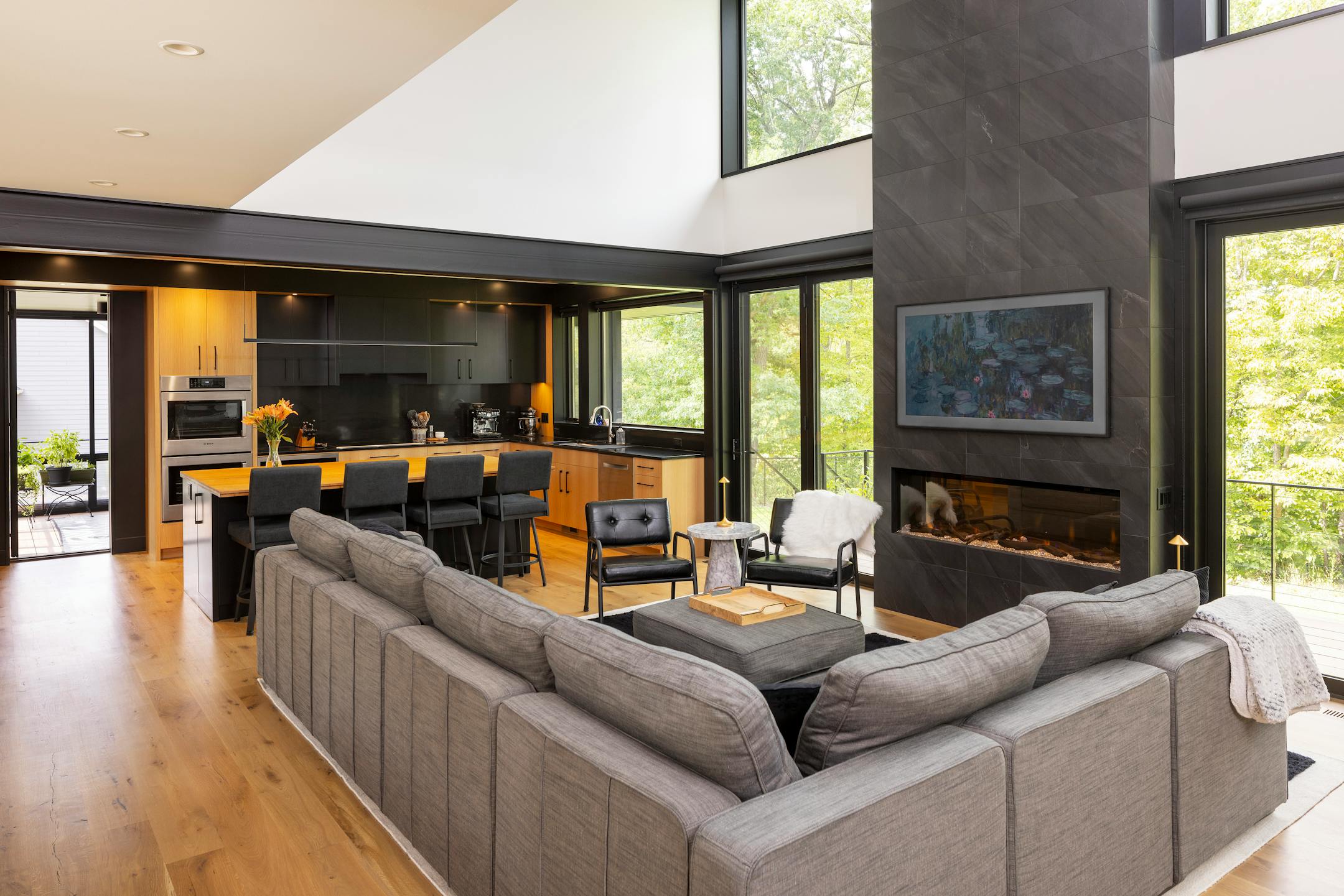 Nestled in the prairie on a gentle slope overlooking a pond, a site in Bloomington presented the perfect opportunity to build a net-zero home. The all-electric, highly insulated house with triple-pane windows, high-efficiency appliances, LED lighting, solar-paneled roof and geothermal heat pump system produces as much electricity as it consumes. Cedar accents and black corrugated metal help define the home’s elegance, as does a dream kitchen, two-story living and dining space as well as screened porches that maximize outdoor views.