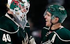 Wild goalie Devan Dubnyk and Zach Parise celebrated at the end of a game in 2015.
