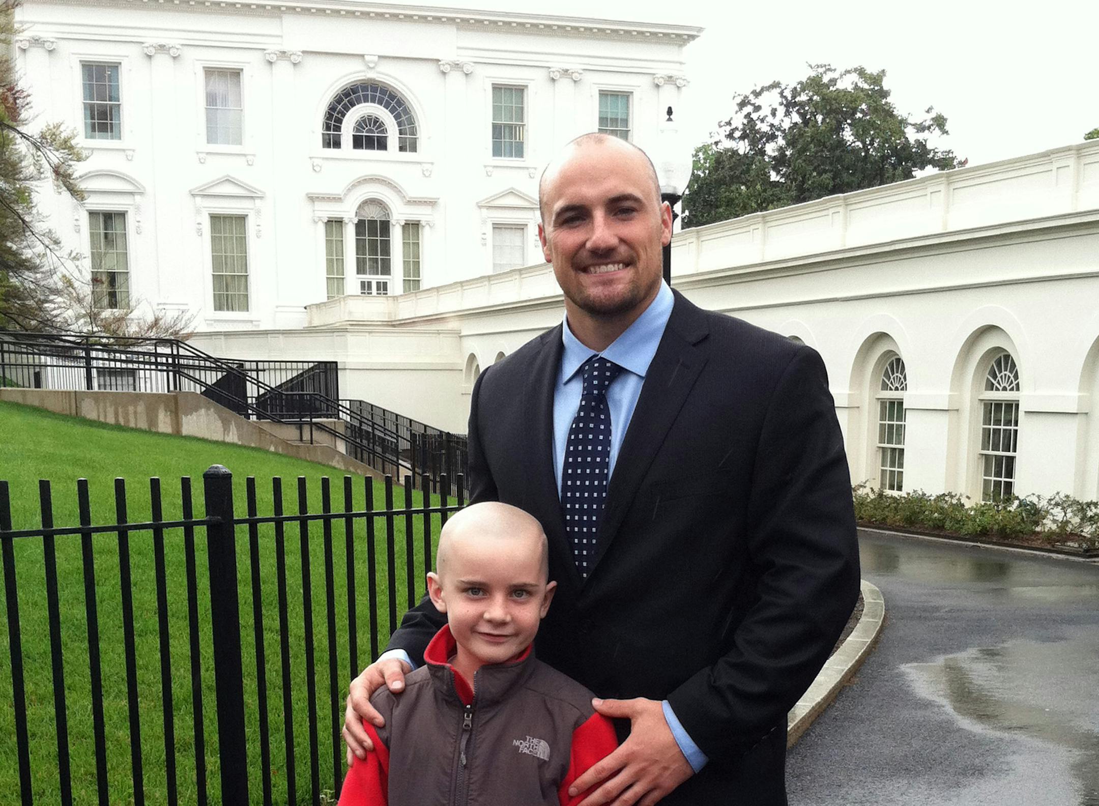 FILE - In this April 29, 2013 file photo provided by Andy Hoffman, his son Jack stands with former Nebraska football player Rex Burkhead after meeting with President Barack Obama in Washington. Andy Hoffman, the father of Jack Hoffman, said Monday, Oct. 7, 2013, that his family has been thankful and cautiously excited since learning last week that Jack's brain cancer is in remission. Jack captured the hearts of Nebraska football fans when, with the help of the players, he ran for a touchdown dur