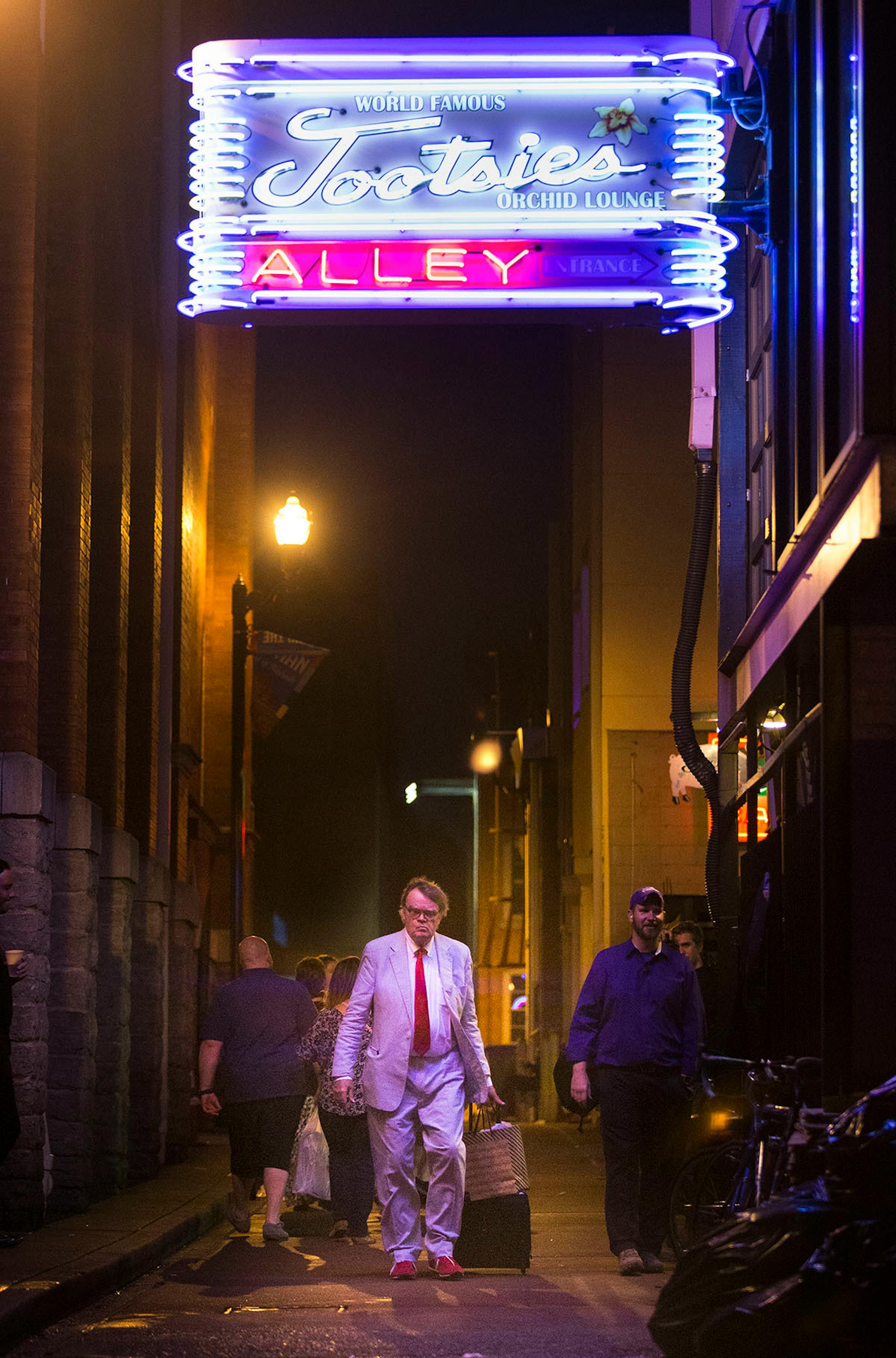 Garrison Keillor walks through the alley from the stage entrance of the Ryman Auditorium after the show.