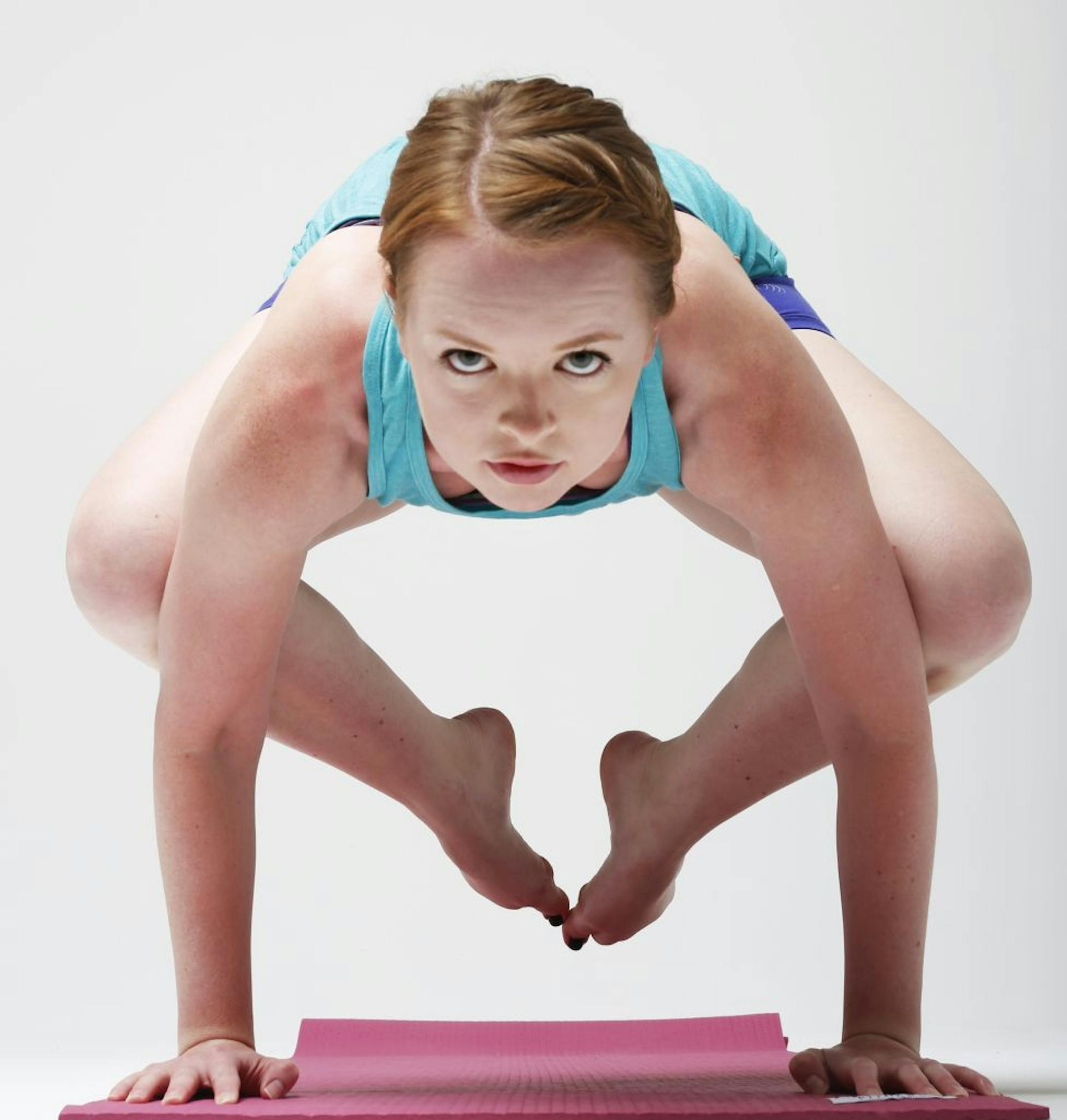Jenna Hanson demonstrates the yoga crow pose.