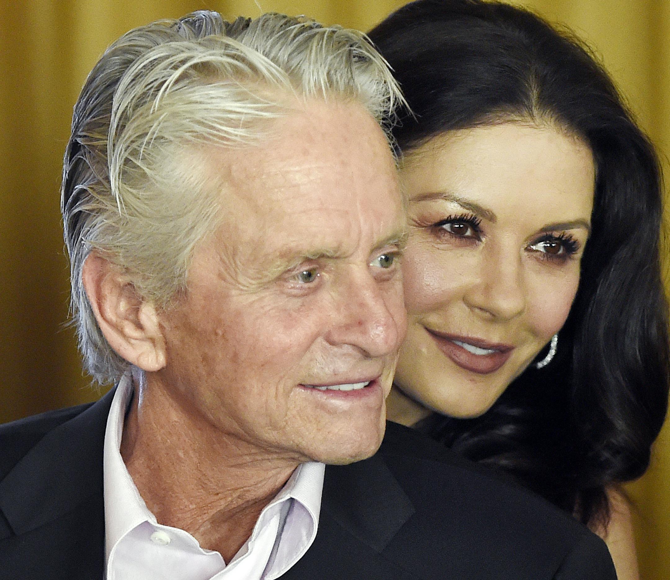 FILE - In this Dec. 9. 2016, file photo, actor Michael Douglas and his wife, actress Catherine Zeta-Jones, attend a party at the Beverly Hills Hotel in Beverly Hills, Calif. Catherine Zeta-Jones said that her husband, who has denied allegations of sexual harassment, is a strong supporter of the #MeToo movement. (Photo by Chris Pizzello/Invision/AP, File)