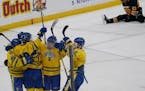 Defending champion St. Cloud Cathedral celebrated one of its 11 goals against Mankato East/Loyola during Thursday's Class 1A quarterfinal at Xcel Ener