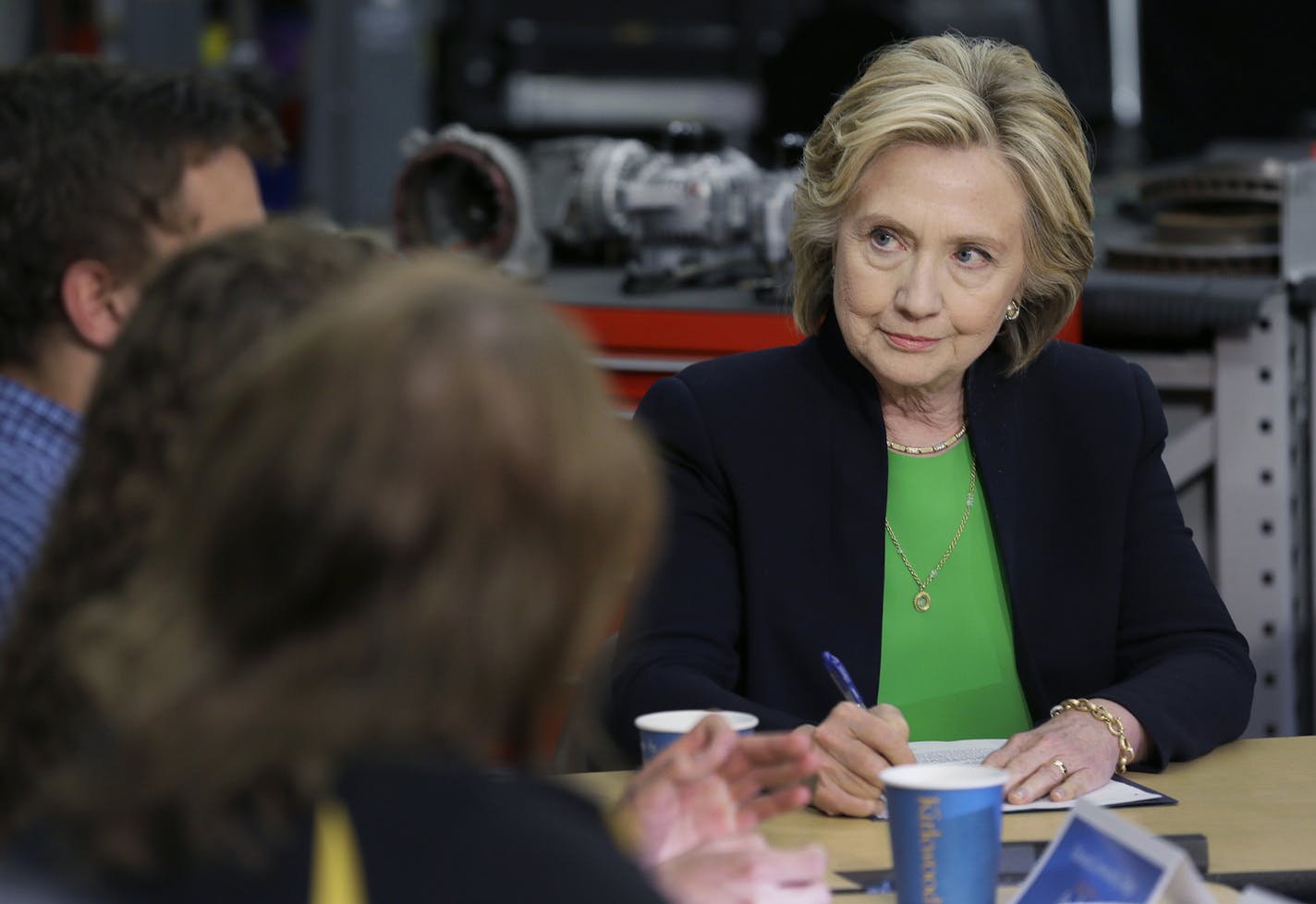 Democratic presidential candidate Hillary Rodham Clinton takes notes during a roundtable with educators and students at the Kirkwood Community College's Jones County Regional Center, Tuesday, April 14, 2015, in Monticello, Iowa. (AP Photo/Charlie Neibergall) ORG XMIT: MIN2015041414355145