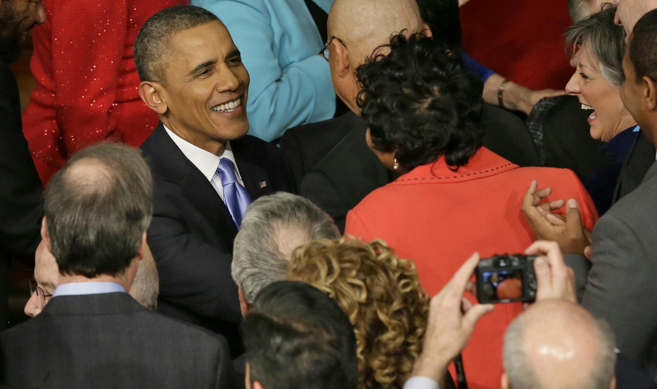President Barack Obama is greeted as he arrives to give his State of the Union address on Capitol Hill in Washington, Tuesday Jan. 28, 2014. (AP Photo/J. Scott Applewhite) ORG XMIT: MIN2014012820273703