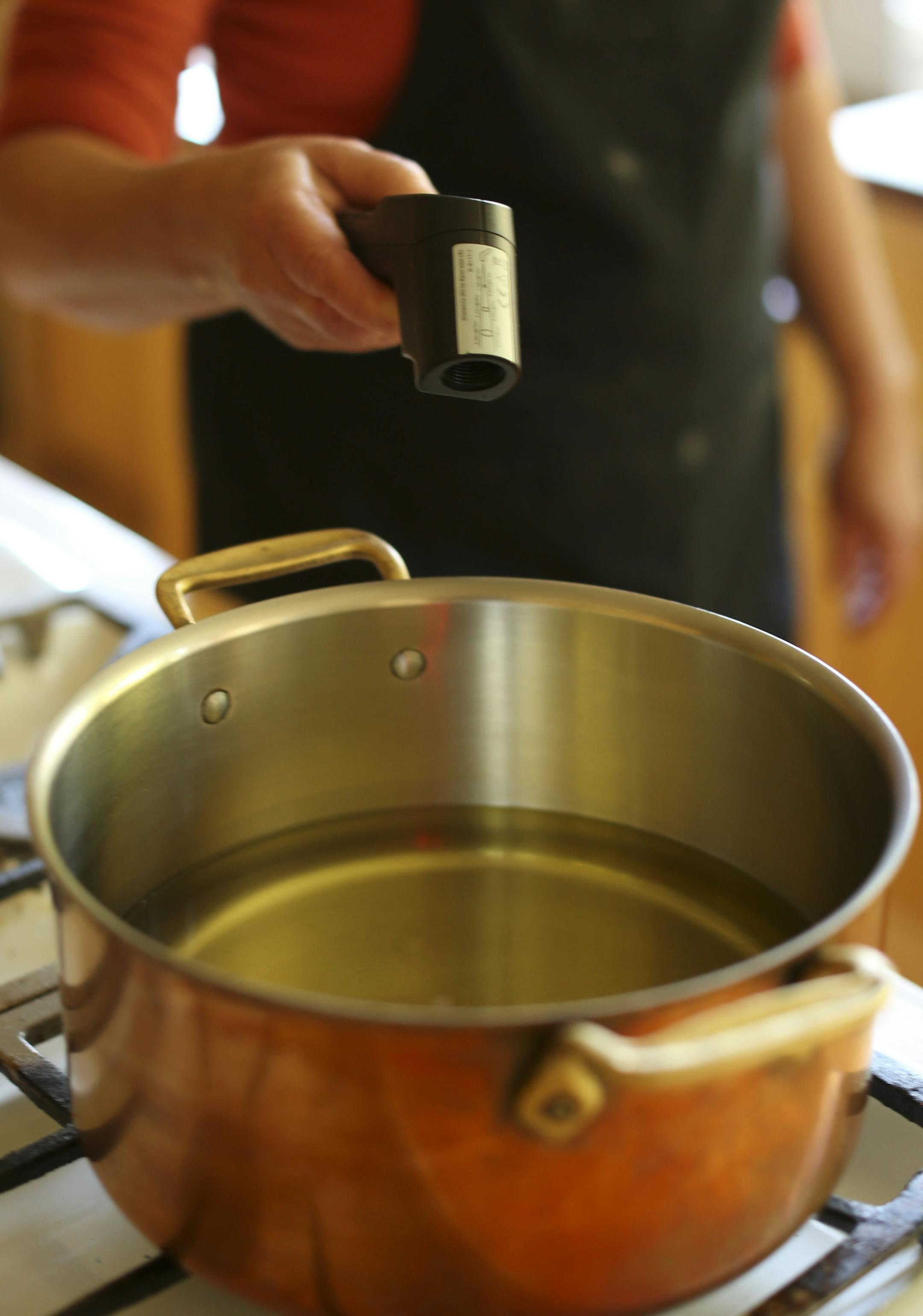 Baking Central takes on krofi, the light and lemony fried pastry from Slovenia. Krofi preparation in Kim Ode's Edina kitchen on Thursday afternoon, October 10, 2013. Taking a moment while mixing the dough to check the temperature of the oil with an infrared thermometer. ] JEFF WHEELER ‚Ä¢ jeff.wheeler@startribune.com