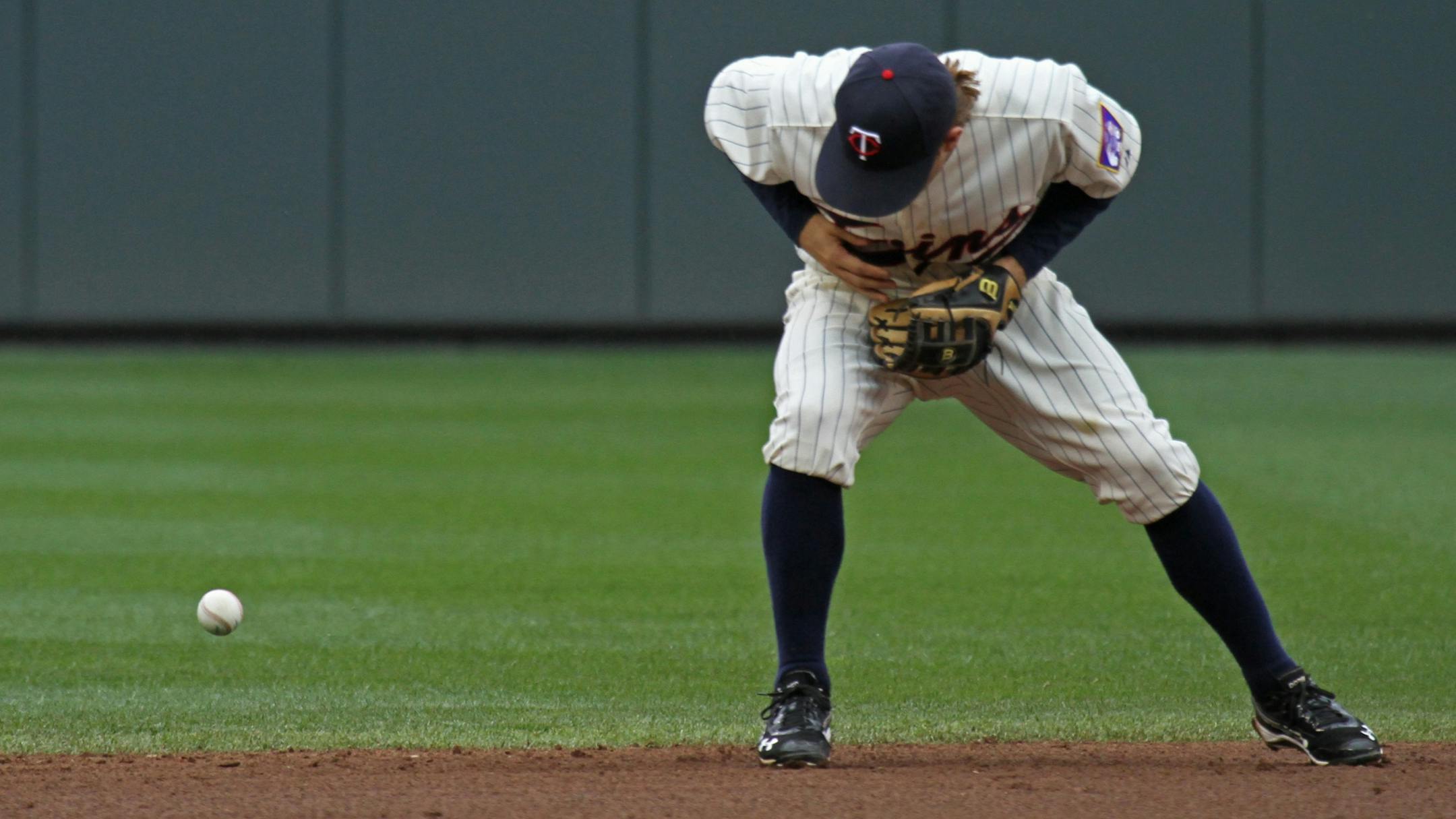 Minnesota Twins vs Detroit Tigers, Target Field, 5/26/12. (left to right) Brian Dozier couldn't handle a Delmon Young hit in the 8th inning as was charged with an error.