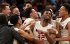 Minnehaha Academy forward JaVonni Bickham (42) was mobbed by his teammates as they celebrated the win. ] ANTHONY SOUFFLE &#xef; anthony.souffle@startr
