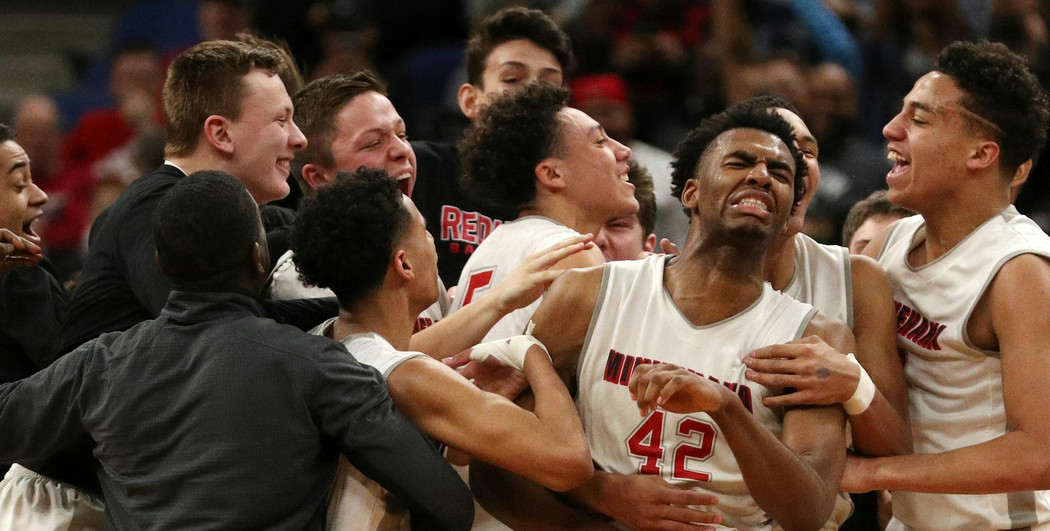 Minnehaha Academy forward JaVonni Bickham (42) was mobbed by his teammates as they celebrated the win. ] ANTHONY SOUFFLE ï anthony.souffle@startribune.com Players competed during the boys' basketball state tournament Class 2A championship game between Cambridge-Isanti High School and Minnehaha Academy Saturday, March 25, 2017 at the Target Center in Minneapolis.