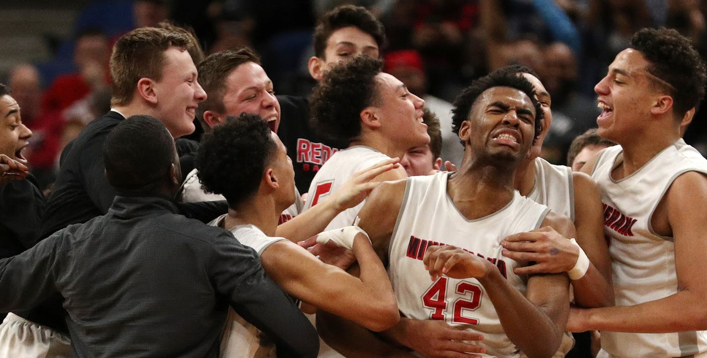 Minnehaha Academy forward JaVonni Bickham (42) was mobbed by his teammates as they celebrated the win. ] ANTHONY SOUFFLE &#xef; anthony.souffle@startribune.com Players competed during the boys' basketball state tournament Class 2A championship game between Cambridge-Isanti High School and Minnehaha Academy Saturday, March 25, 2017 at the Target Center in Minneapolis.