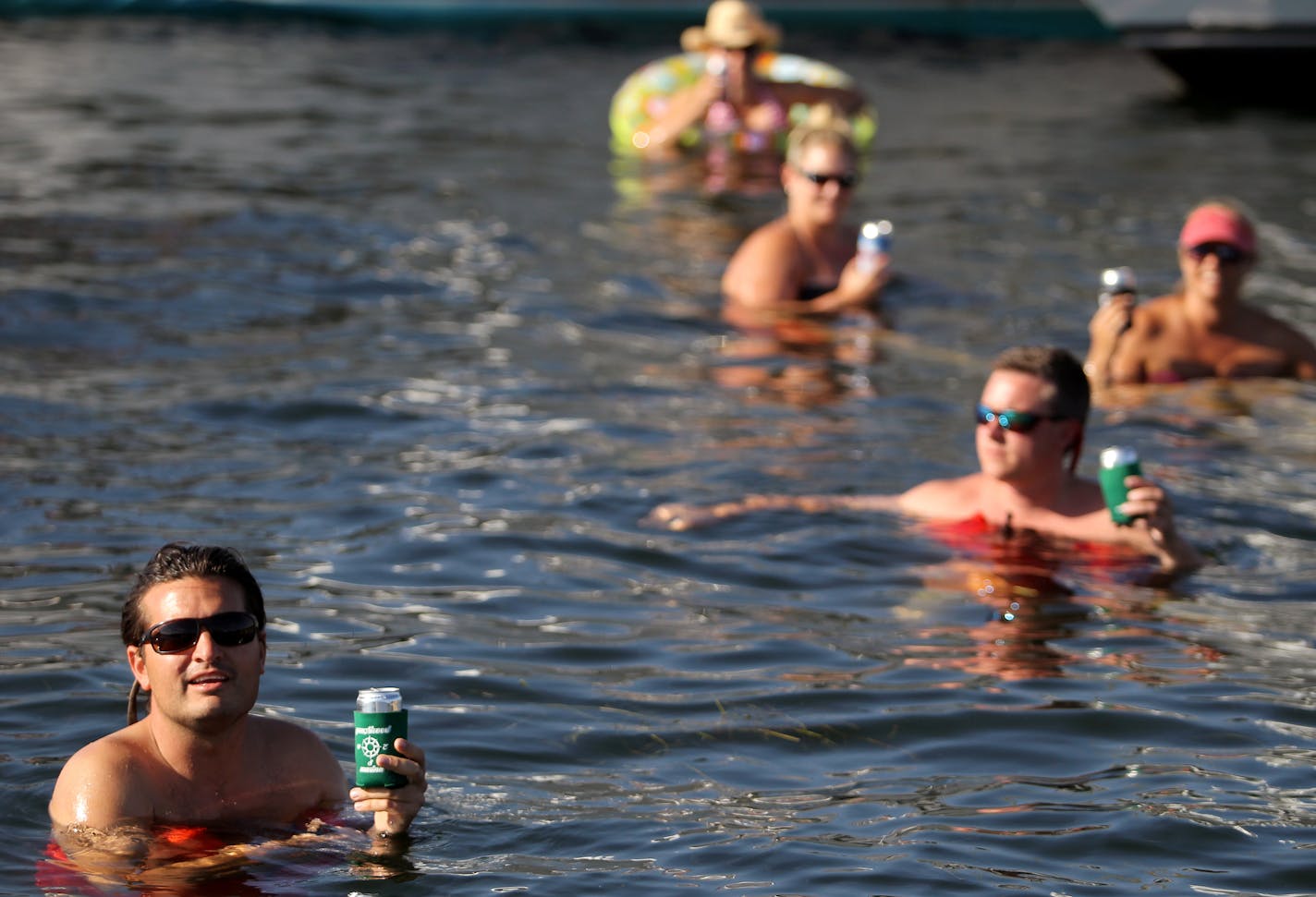 Peter Kinn, far left, of Excelsior, Minn., talks about the modern lifestyle of Cruiser's Cove on Lake Minnetonka near Orono, Minn., on Friday, August 16, 2013. ] (ANNA REED/STAR TRIBUNE) anna.reed@startribune.com (cq)