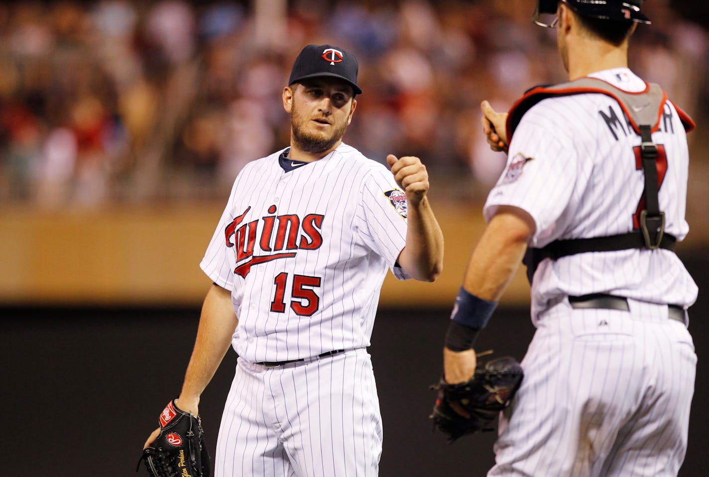 Glen Perkins (15) celebrates with Twins catcher Joe Mauer, right, after a game in 2013.