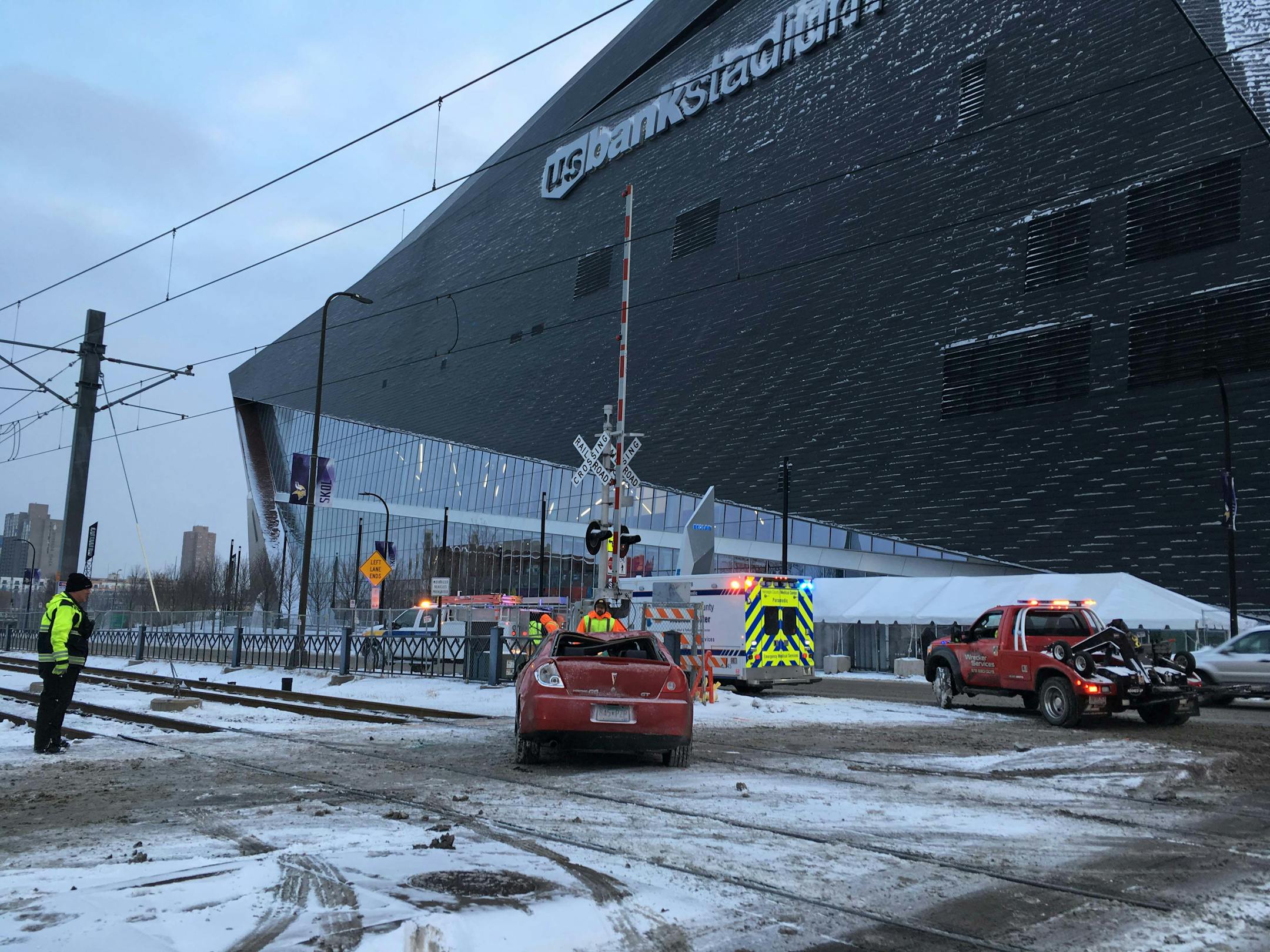 A car sits on the LRT tracks near US Bank Stadium Thursday afternoon. The car had been on its roof before being set upright. ] Jenni Pinkley Star Tribune 12/28/2018 Minneapolis, MN