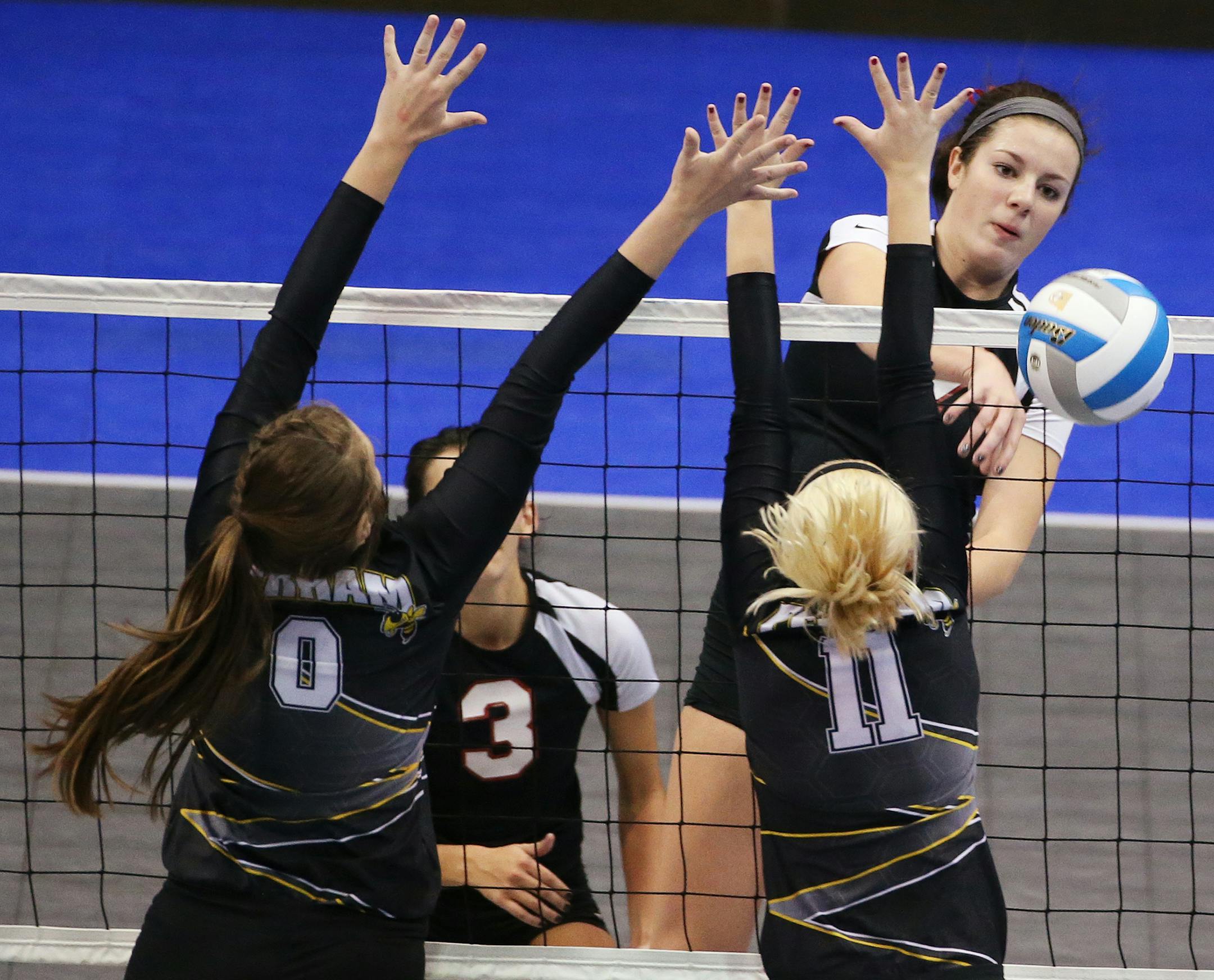 Mariena Hayden of Belle Plaine spikes the ball past Ella Von Ruden, left, and Alex Lubitz of Perham. ] (Leila Navidi/Star Tribune) leila.navidi@startribune.com Belle Plaine plays Perham in the Class 2A girls volleyball state quarterfinals at the Xcel Energy Center in St. Paul on Thursday, November 12, 2015.