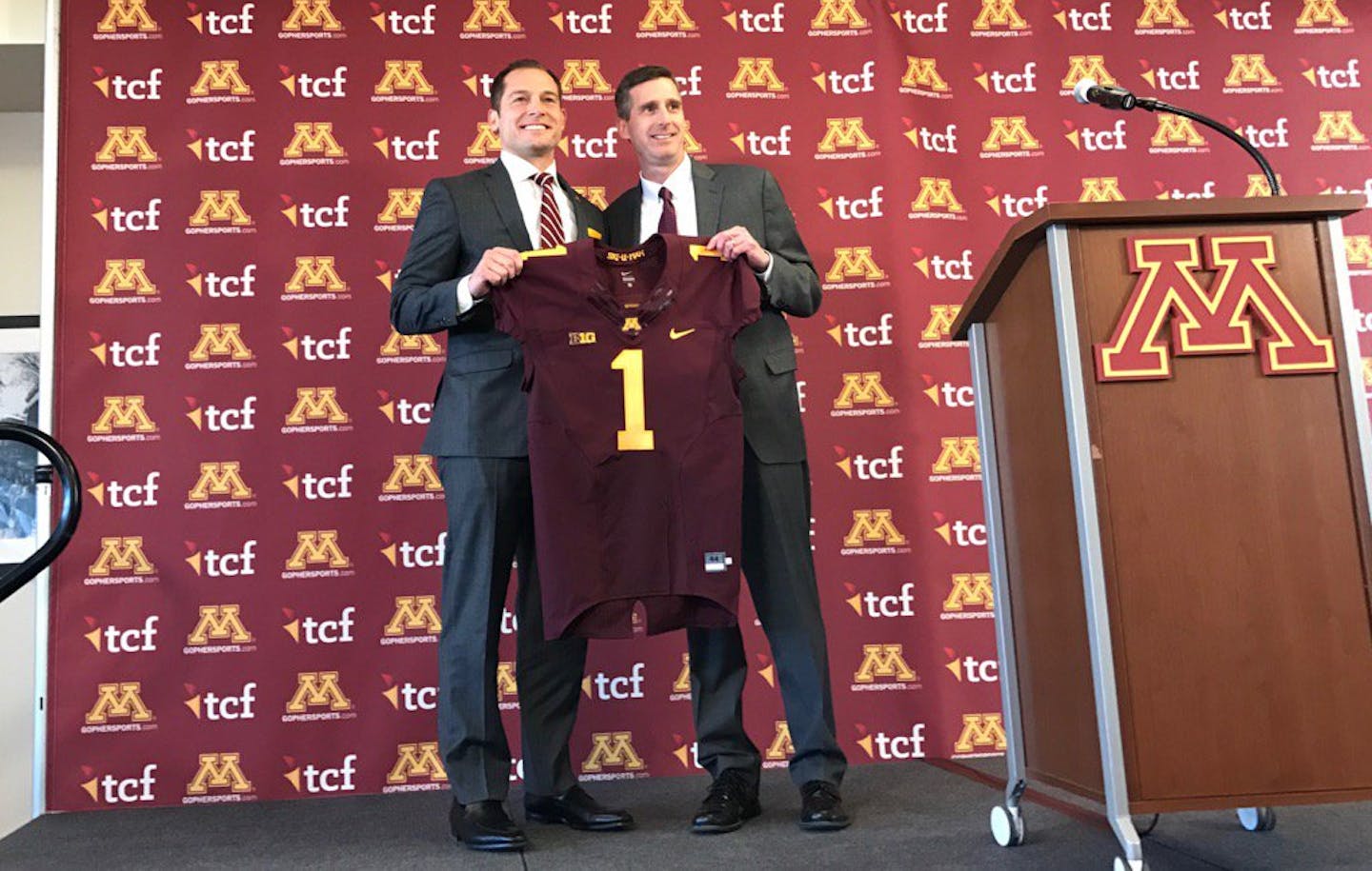 New football coach P.J. Fleck was greeted by athletic director Mark Coyle at the start of Friday's press conference.