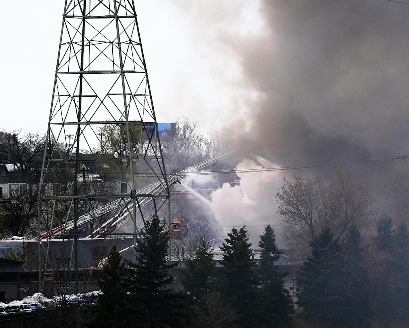 Firefighters put water on a fire burning at Northern Metal Recycling Wednesday in Minneapolis. ]