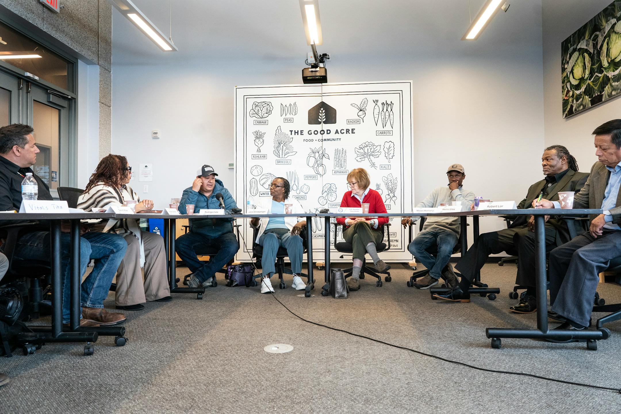 U.S. Senator Tina Smith, (center) listens as Rodrigo Cala , at left along with other BIPOC farmers met at  the Good Acre.