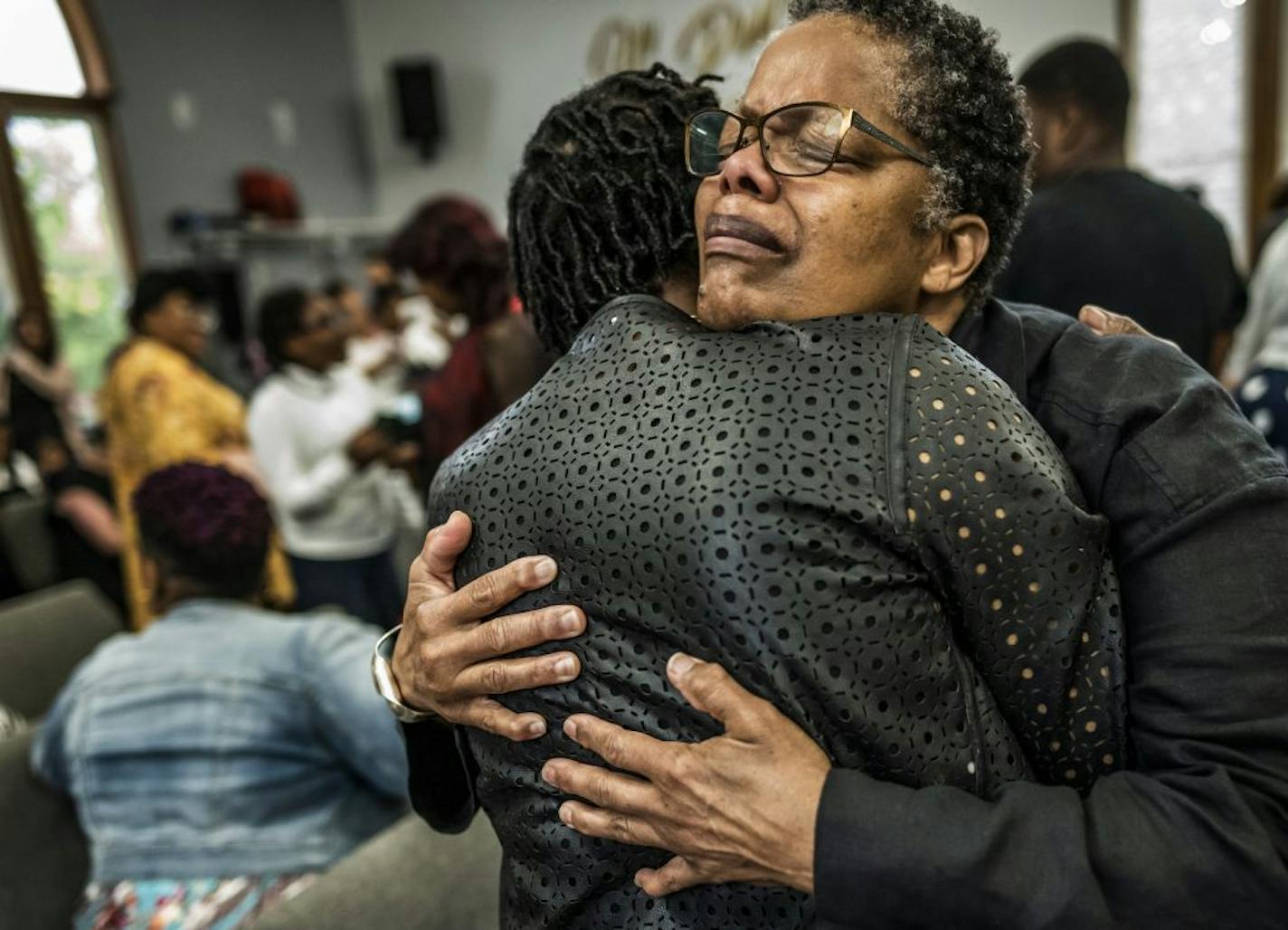 Valerie Land, the aunt of RayVell Carter, got a hug from parishioner Susie Hodges at St. Albans Church of God in St. Paul on Sunday.